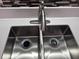 A stainless steel kitchen sink features a modern faucet and a speckled countertop at 1735 Boone Hall Dr # K6, Charleston, SC 29407