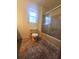 Bathroom featuring tile floors, a standard toilet, and shower/tub combo and a window at 18808 Round O Rd, Round O, SC 29474