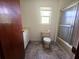 Bathroom featuring vinyl floors, white vanity, standard toilet, and shower/tub combo at 18808 Round O Rd, Round O, SC 29474