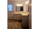 Bathroom featuring a sink with cabinet storage, a mirror, and linoleum floors at 18808 Round O Rd, Round O, SC 29474