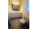 Bathroom featuring vinyl floors, white vanity, standard toilet, and shower/tub combo at 18808 Round O Rd, Round O, SC 29474