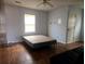 Bedroom featuring wood floors, a queen bed, and a window with white blinds at 18808 Round O Rd, Round O, SC 29474