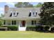 Charming two-story home with white siding, dormer windows and a welcoming front porch at 18808 Round O Rd, Round O, SC 29474