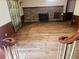View of the living room with hardwood floors and fireplace, seen from the staircase landing at 18808 Round O Rd, Round O, SC 29474