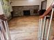 View of the living room with hardwood floors and fireplace, seen from the staircase at 18808 Round O Rd, Round O, SC 29474