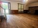 Welcoming living room featuring hardwood floors, a fireplace, and natural light from the front door at 18808 Round O Rd, Round O, SC 29474