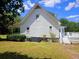 Exterior angle showing two-story home's white siding, back deck, and manicured landscaping at 18808 Round O Rd, Round O, SC 29474