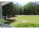 Scenic view of the property's expansive yard, framed by lush greenery and mature trees at 18808 Round O Rd, Round O, SC 29474