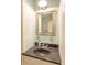 Charming bathroom featuring a framed mirror and a sleek black countertop at 192 Ashley Ave # C, Charleston, SC 29403