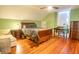 Spacious bedroom with a ceiling fan, a window, and shiny hardwood floors at 192 Ashley Ave # C, Charleston, SC 29403