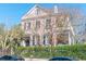 Elegant Charleston home with a pink facade, wrought iron fence, and beautiful architectural details at 192 Ashley Ave # C, Charleston, SC 29403