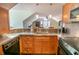Bright kitchen featuring stainless steel counters, wooden cabinets, and pendant lighting at 192 Ashley Ave # C, Charleston, SC 29403