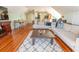 Open-concept living room with a large sofa, hardwood floors, and an adjoining dining and kitchen area at 192 Ashley Ave # C, Charleston, SC 29403