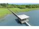 Aerial view of a private dock sitting on the water, surrounded by beautiful trees and green marsh grasses at 2027 Riverbend Dr, Charleston, SC 29412
