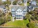 Stunning aerial view of large beachfront home with expansive decks and manicured lawn at 2107 Club View Ct, Charleston, SC 29412