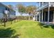 Serene backyard with lush green lawn and mature trees, offering privacy at 2107 Club View Ct, Charleston, SC 29412