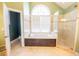 Bathroom featuring a soaking tub, tiled shower, and large window at 2107 Club View Ct, Charleston, SC 29412