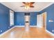 Spacious bedroom with hardwood floors, natural light, and soothing blue walls at 2107 Club View Ct, Charleston, SC 29412
