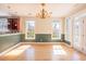Bright dining area featuring elegant lighting, hardwood flooring, and large windows at 2107 Club View Ct, Charleston, SC 29412