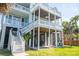 Multi-level beachfront property showcasing outdoor stairs and balconies, complemented by lush landscaping and architectural details at 2107 Club View Ct, Charleston, SC 29412