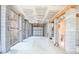 A spacious garage features an unfinished ceiling and cinder block supports with a white metal garage door at 2107 Club View Ct, Charleston, SC 29412