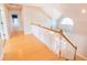 Hallway with hardwood floors, white railing, and natural light from the window at 2107 Club View Ct, Charleston, SC 29412