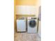 Bright laundry room features modern washer and dryer and ample cabinet space at 2107 Club View Ct, Charleston, SC 29412