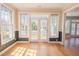 Sun-drenched sitting room with French doors, large windows, and gleaming hardwood floors at 2107 Club View Ct, Charleston, SC 29412