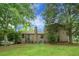 Expansive backyard of the home featuring lush green grass, mature trees, and a brick exterior at 211 Bramblewood Dr, Summerville, SC 29485