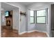 Bright breakfast nook featuring hardwood floors, double windows, and a view into the living room at 211 Bramblewood Dr, Summerville, SC 29485