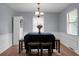 Bright dining room with wood flooring, neutral paint, and a charming chandelier above the table at 211 Bramblewood Dr, Summerville, SC 29485
