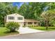 Inviting home featuring a brick facade, well-maintained lawn, and mature trees offering shade at 211 Bramblewood Dr, Summerville, SC 29485