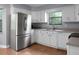 Well-lit kitchen features white cabinetry, stainless steel refrigerator, and practical layout at 211 Bramblewood Dr, Summerville, SC 29485