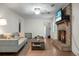 Cozy living room with a brick fireplace, ceiling fan, hardwood floors, and comfortable seating at 211 Bramblewood Dr, Summerville, SC 29485