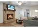 Bright living room featuring a brick fireplace, hardwood floors, and a view into the kitchen at 211 Bramblewood Dr, Summerville, SC 29485