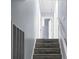 Carpeted staircase leading to the upper level with white banister and access to storage space at 211 Bramblewood Dr, Summerville, SC 29485