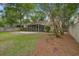 Large backyard with a screened porch, stone patio, and lush landscaping at 2154 Country Manor Dr Dr, Mount Pleasant, SC 29466