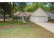 Charming single-story home with a two-car garage and landscaped front yard with mature trees and shrubs at 2154 Country Manor Dr Dr, Mount Pleasant, SC 29466