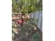 Outdoor garden featuring vibrant red roses and lush greenery bordering a wooden fence at 2154 Country Manor Dr Dr, Mount Pleasant, SC 29466