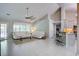 Bright living room featuring vaulted ceilings, tile flooring, and a seamless flow into a modern kitchen at 2154 Country Manor Dr Dr, Mount Pleasant, SC 29466