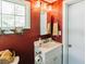 Bathroom featuring a vintage sink, wood-paneled walls, and bright light fixtures at 21785 Lowcountry Hwy, Ruffin, SC 29475