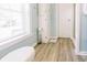 Bright bathroom features wood-look flooring, a toilet, built-in storage and a scale at 21785 Lowcountry Hwy, Ruffin, SC 29475