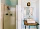 Bathroom with unique vanity, white vessel sink, decorative lighting, and tiled shower at 21785 Lowcountry Hwy, Ruffin, SC 29475