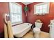 Charming vintage-style bathroom featuring a clawfoot tub, wood-paneled walls, and natural light at 21785 Lowcountry Hwy, Ruffin, SC 29475