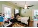 Cozy bedroom with a four-poster bed, wood floors, and plenty of natural light at 21785 Lowcountry Hwy, Ruffin, SC 29475