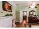 Inviting bedroom with fireplace, antique furnishings, and doorway to another room at 21785 Lowcountry Hwy, Ruffin, SC 29475