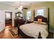 Bright bedroom with four-poster bed, wooden floors, and doorway to another room at 21785 Lowcountry Hwy, Ruffin, SC 29475