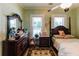 Comfortable bedroom featuring a four-poster bed, wood floors, and ample natural light at 21785 Lowcountry Hwy, Ruffin, SC 29475