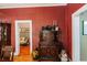 Dining room with red wall, wood floors, and antique furniture at 21785 Lowcountry Hwy, Ruffin, SC 29475