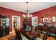 Elegant dining room with wood floors, chandelier, and antique furniture at 21785 Lowcountry Hwy, Ruffin, SC 29475